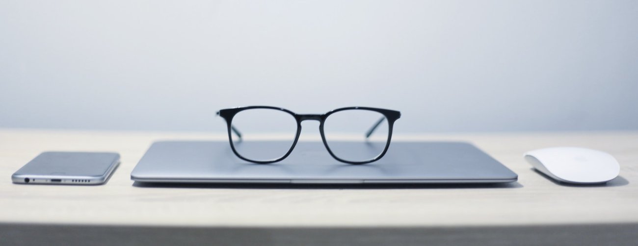 image of spectacles sitting on laptop