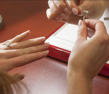 photo of a woman's hand receiving a diamond they are about to try on.