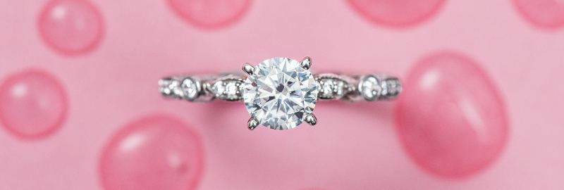 a solitaire diamond ring on a pink background. Image courtesy of James Allen®